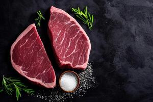 The raw steak on the black background with . photo