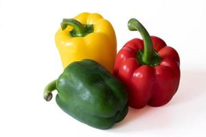 Red and green sweet bell pepper with water drops isolated on white background. photo