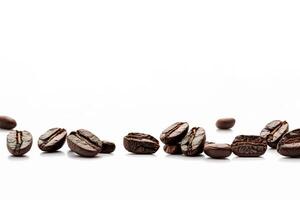 Roasted coffee beans on white background with copy space. photo