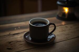 A cup of hot black coffee on a wooden table, in a vintage atmosphere. photo