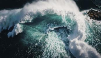 Spectacular aerial top view background photo of ocean sea water white wave splashing in the deep sea. Drone photo backdrop of sea wave in bird eye waves, Generate Ai