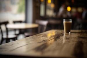 Wooden table in front of abstract blurred coffee shop background. photo