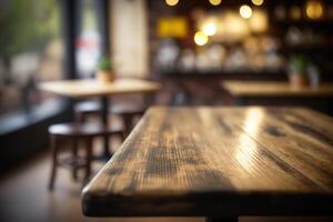 Wooden table in front of abstract blurred coffee shop background. photo