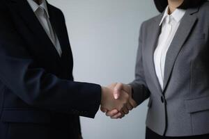 Photo of a man and women shaking hands after business deal