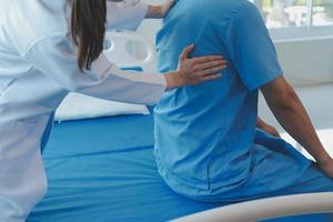 Patient doing some special exercises under supervision in a room photo