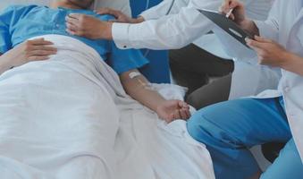 Injured patient showing doctor broken wrist and arm with bandage in hospital office or emergency room. Sprain, stress fracture or repetitive strain injury in hand. Nurse helping customer. First aid. photo