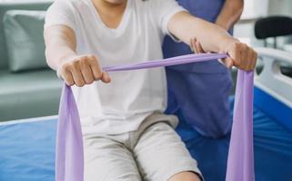 Physiotherapist working with patient in clinic, closeup photo