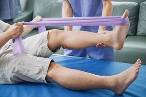 Physiotherapist working with patient in clinic, closeup photo