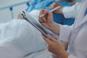 Injured patient showing doctor broken wrist and arm with bandage in hospital office or emergency room. Sprain, stress fracture or repetitive strain injury in hand. Nurse helping customer. First aid. photo