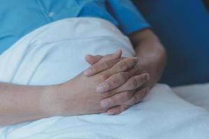 Injured patient showing doctor broken wrist and arm with bandage in hospital office or emergency room. Sprain, stress fracture or repetitive strain injury in hand. Nurse helping customer. First aid. photo