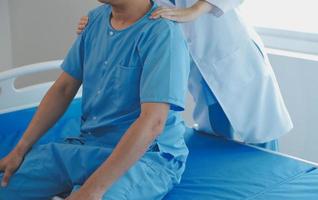 Patient doing some special exercises under supervision in a room photo