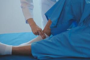 Patient doing some special exercises under supervision in a room photo