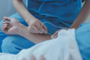 Injured patient showing doctor broken wrist and arm with bandage in hospital office or emergency room. Sprain, stress fracture or repetitive strain injury in hand. Nurse helping customer. First aid. photo