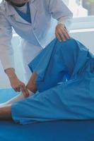 Patient doing some special exercises under supervision in a room photo