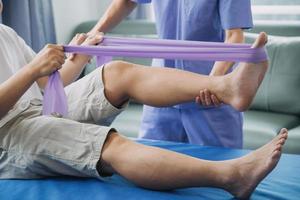 Physiotherapist working with patient in clinic, closeup photo