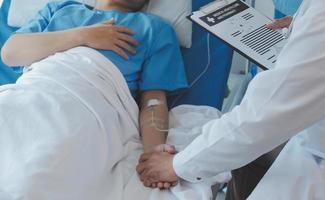 Injured patient showing doctor broken wrist and arm with bandage in hospital office or emergency room. Sprain, stress fracture or repetitive strain injury in hand. Nurse helping customer. First aid. photo