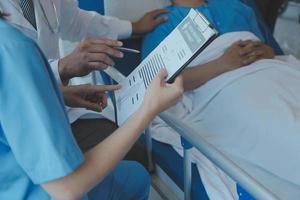 Injured patient showing doctor broken wrist and arm with bandage in hospital office or emergency room. Sprain, stress fracture or repetitive strain injury in hand. Nurse helping customer. First aid. photo