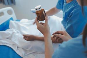 Injured patient showing doctor broken wrist and arm with bandage in hospital office or emergency room. Sprain, stress fracture or repetitive strain injury in hand. Nurse helping customer. First aid. photo