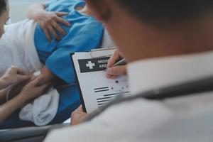 Injured patient showing doctor broken wrist and arm with bandage in hospital office or emergency room. Sprain, stress fracture or repetitive strain injury in hand. Nurse helping customer. First aid. photo