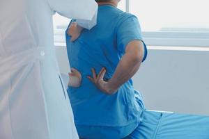 Patient doing some special exercises under supervision in a room photo