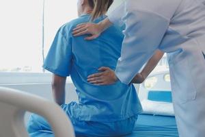 Patient doing some special exercises under supervision in a room photo