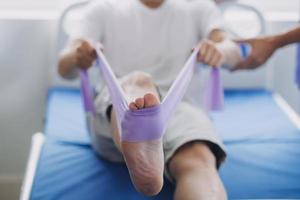 Physiotherapist working with patient in clinic, closeup photo