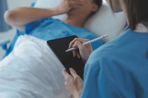 Injured patient showing doctor broken wrist and arm with bandage in hospital office or emergency room. Sprain, stress fracture or repetitive strain injury in hand. Nurse helping customer. First aid. photo