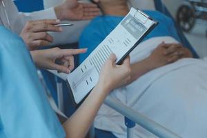 Injured patient showing doctor broken wrist and arm with bandage in hospital office or emergency room. Sprain, stress fracture or repetitive strain injury in hand. Nurse helping customer. First aid. photo