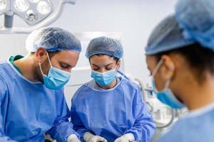 Shot of a team of surgeons performing a surgery in an operating theatre photo