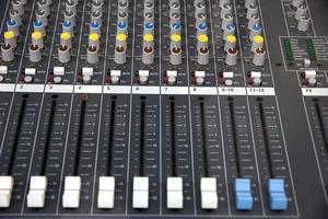 Audio sound mixer console. Music mixer control panel in a recording studio. Audio mixing console with faders and adjusting knob. photo