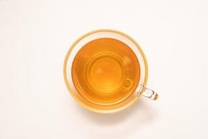 Glass cup of hot ginger tea isolated on white background. photo