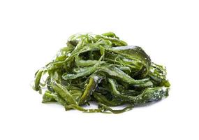 heap of fresh Korean seaweed salad stem side dish or Miyeok Julgi Bokkeum isolated on white background. Laminaria or Kelp Seaweed stem photo