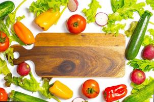 Flat lay composition with fresh ripe vegetables on white background.    Flat lay set of seasonal vegetables on a white background. Frame of various vegetables on a white background photo