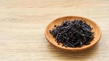 seaweed sargassum fusiforme or Hijiki seaweed in wood plate on wooden table background photo