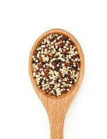 top view or flat lay quinoa seeds in wooden spoon isolated on white background. close up quinoa seeds in wooden spoon isolated on white background. quinoa seeds in spoon isolated photo