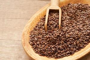 flaxseed linseed in wood bowl on wooden table background. close up flaxseed linseed. flaxseed linseed photo
