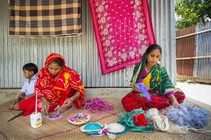 Bangladesh May 14, 2018 Craft village where craftswomen are making home and office used showpiece on pineapple leaf fibers and banana fiber at Tangail, Bangladesh. photo