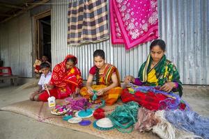 Bangladesh May 14, 2018 Craft village where craftswomen are making home and office used showpiece on pineapple leaf fibers and banana fiber at Tangail, Bangladesh. photo