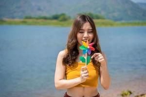 Young lgbt woman holding colorful turbine on the beach. Supporters of the LGBT community photo