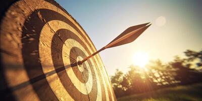 high success concept A red dart arrow aims at the target in the center of the dartboard. Target hit in the middle. . photo