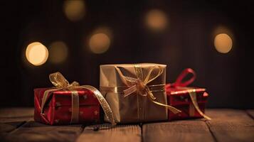 Christmas presents wrapped in red paper with gold ribbon on on wooden table background and bokeh. Place for typography and logo. Copy space. . photo