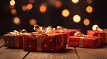 Christmas presents wrapped in red paper with gold ribbon on on wooden table background and bokeh. Place for typography and logo. Copy space. . photo