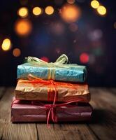 Christmas presents wrapped in colorful paper with ribbon on wooden table background and bokeh. Place for typography and logo. Copy space. . photo