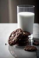 Vertical image of chocolate cookies with a glass of milk. . photo