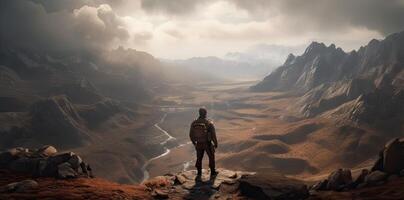 Sporty man on the mountain peak looking on mountain valley with sunbeams at colorful sunset in autumn. Landscape traveler, foggy hills, forest in fall, amazing sky and sunlight in fall. photo