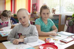 Elementary children with pencils and notebooks. photo