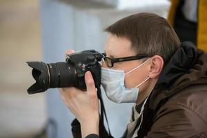 A meeting of people with a presidential candidate. Photographer in a medical mask. photo