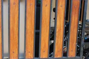 Photo of a symmetrical brown and black iron picket fence