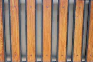 Photo of a symmetrical brown and black iron picket fence