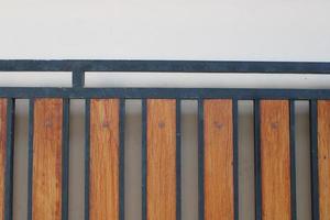 Photo of a symmetrical brown and black iron picket fence